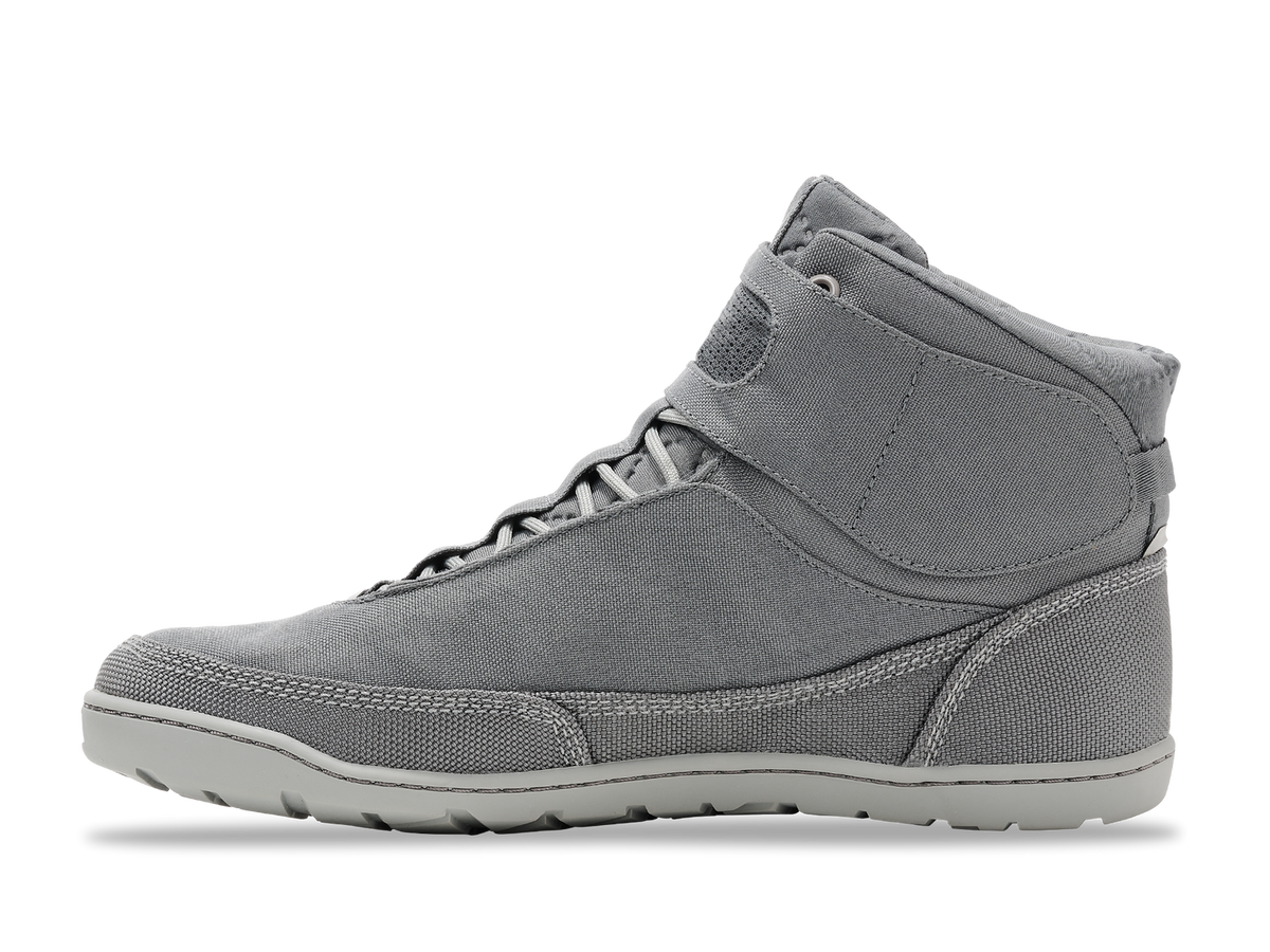 Hiyak | Astral gray high-top shoe, side view. Textile upper with white laces, light gray sole on black background.