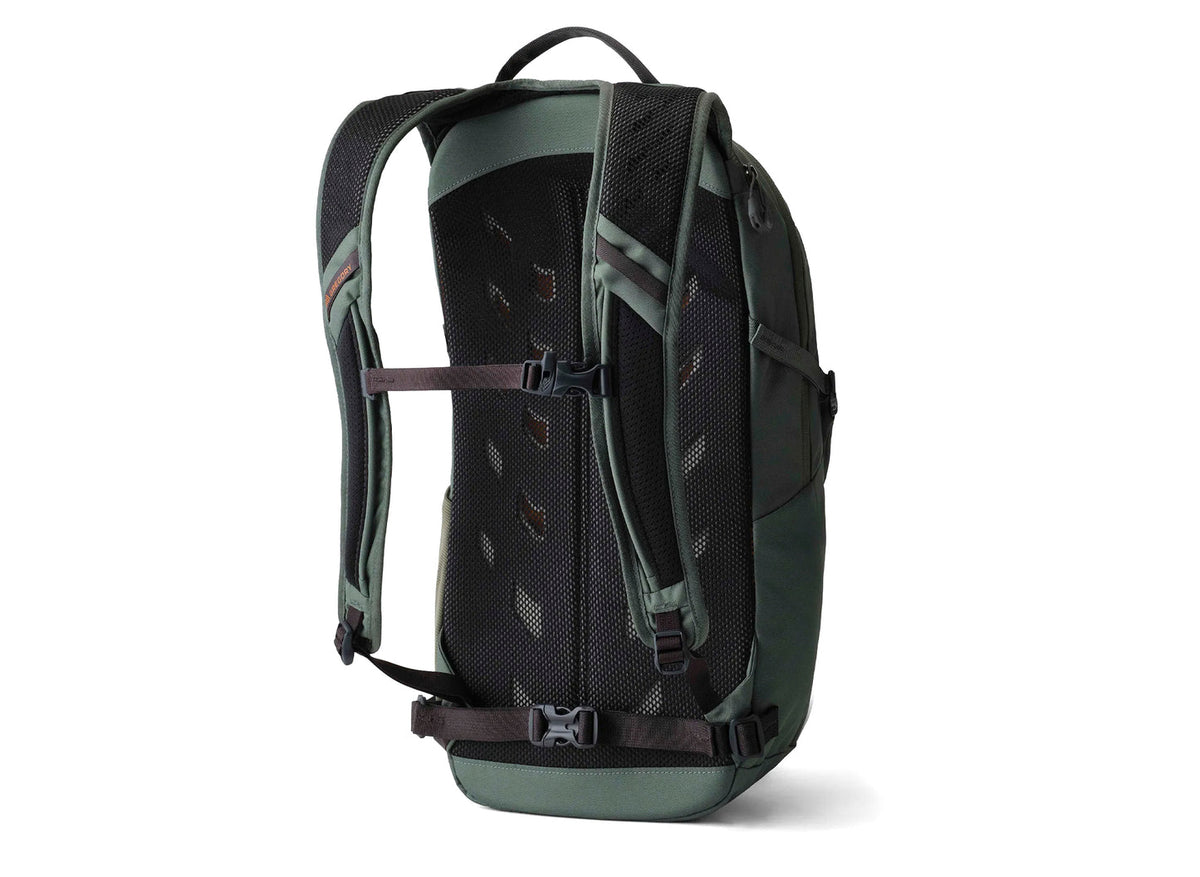 Gregory Nano 18 backpack in green, showing the padded mesh back panel, shoulder straps, and adjustable chest and waist buckles.