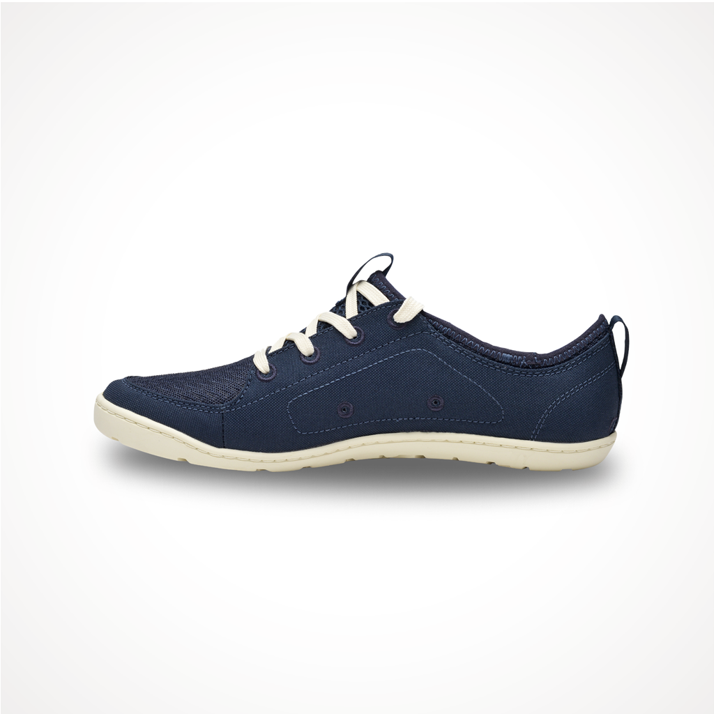 Loyak AW | Astral barefoot shoe, side view. Dark blue sneaker with white laces and cream sole on a white background.